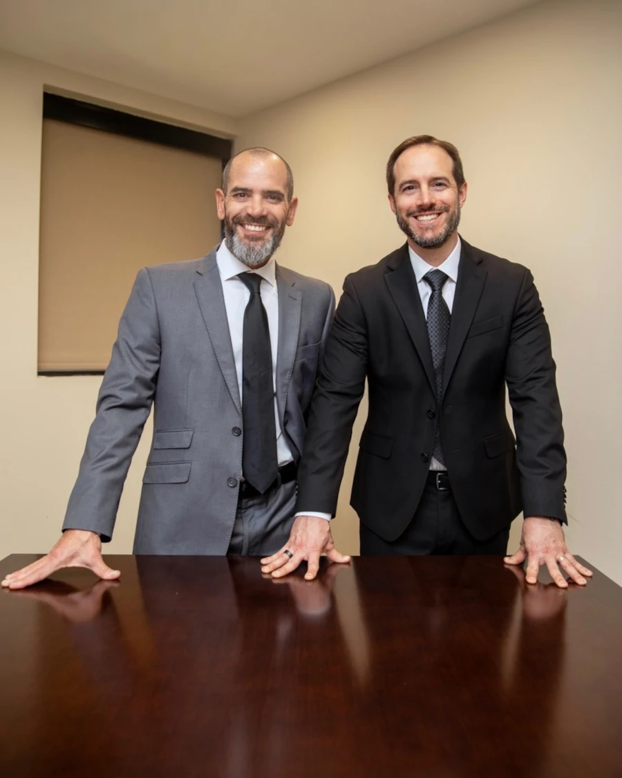 Daniel and Brian Standing at a desk